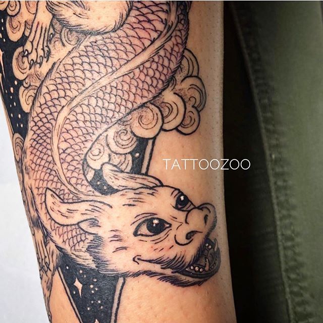 "Having a luck dragon with you is the only way to go on a quest." (tattoo by @gerikramertattoos)